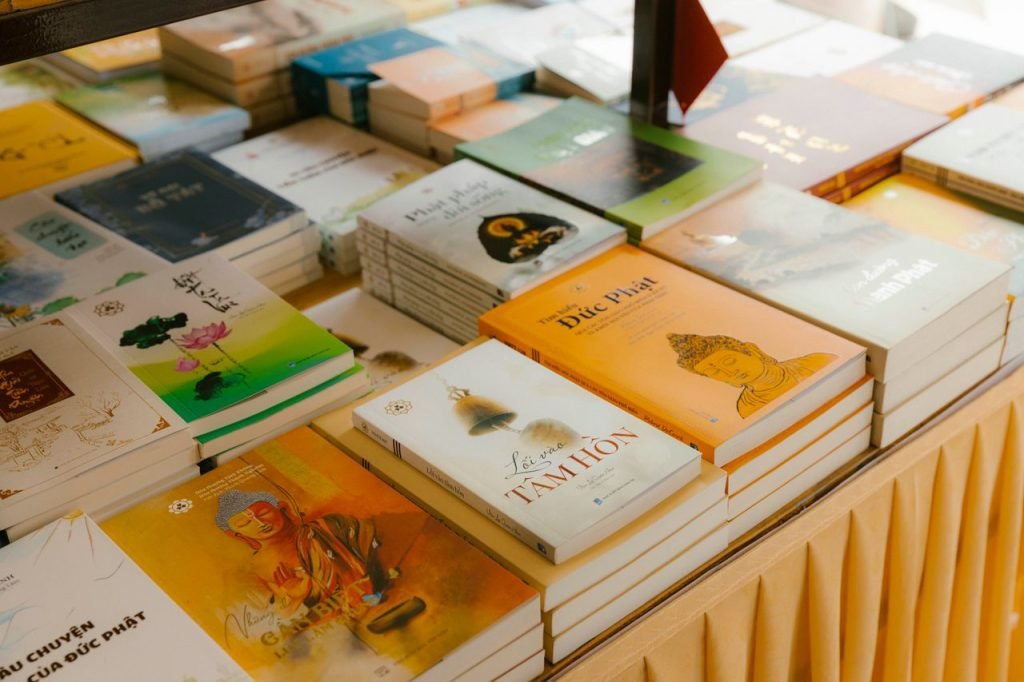 Crafting Captivating Headlines: Your awesome post title goes here A diverse collection of books neatly arranged on a table indoors.